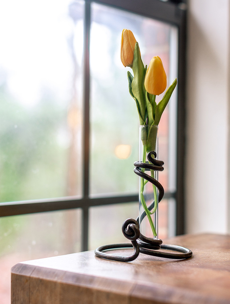 Is the 6" height of the Rose Bud Vase at the top of the glass tube or the iron sculpture? Thank You.